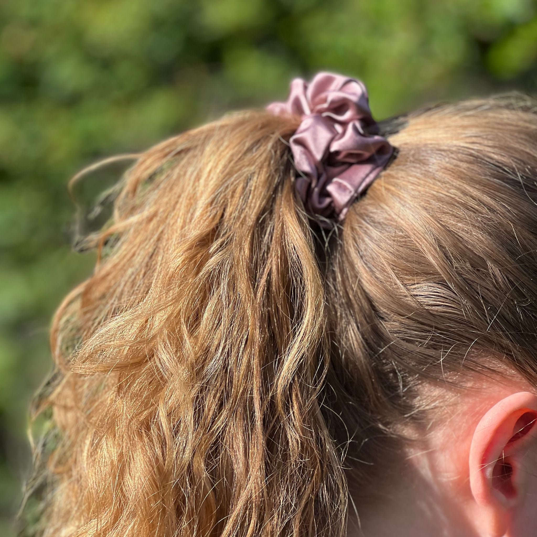 dusty pink silk scrunchie in a high ponytail