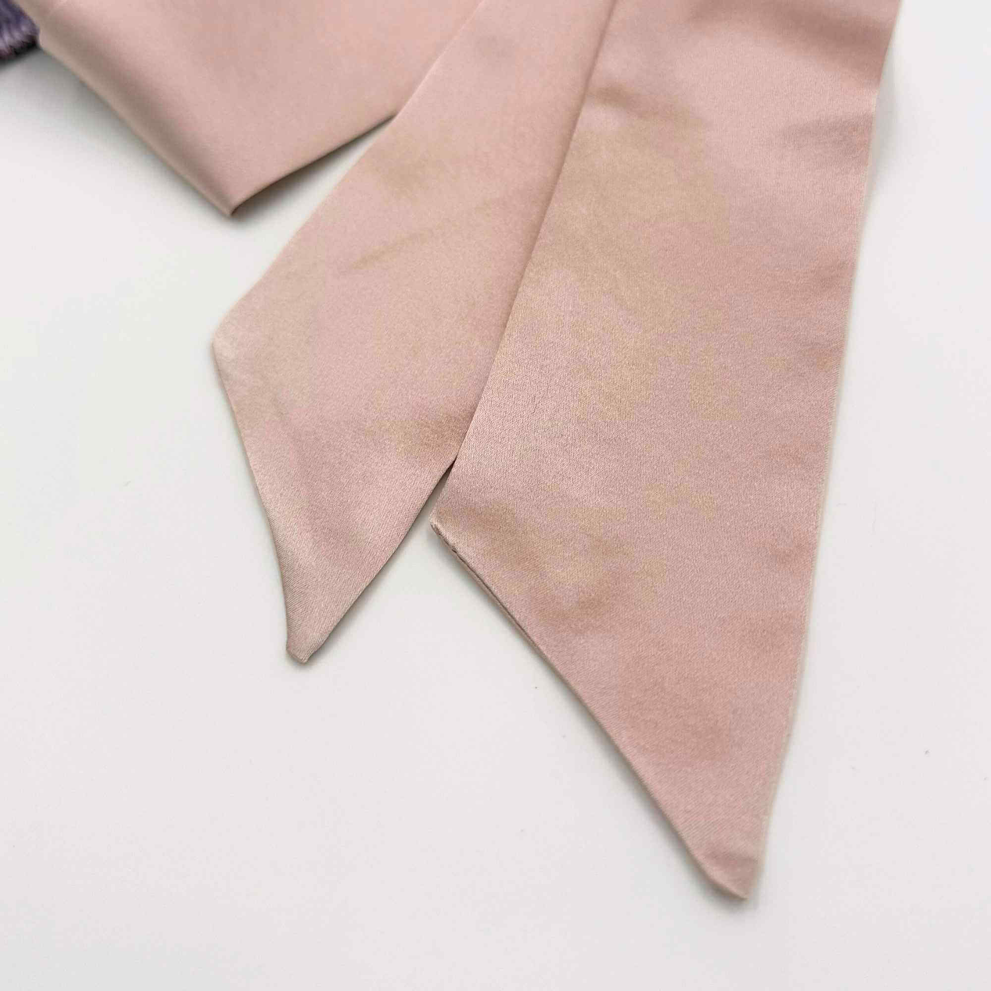 close up of pink ties on reversible silk bonnet