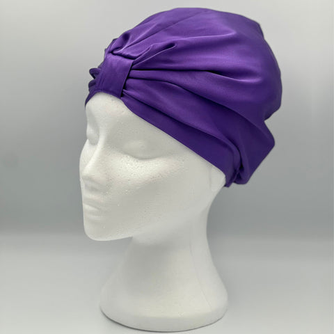 Side view of a purple silk bonnet on a mannequins head