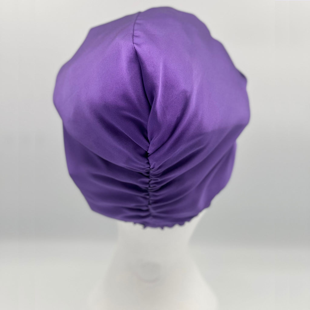 Back view of a purple silk bonnet on a mannequins head