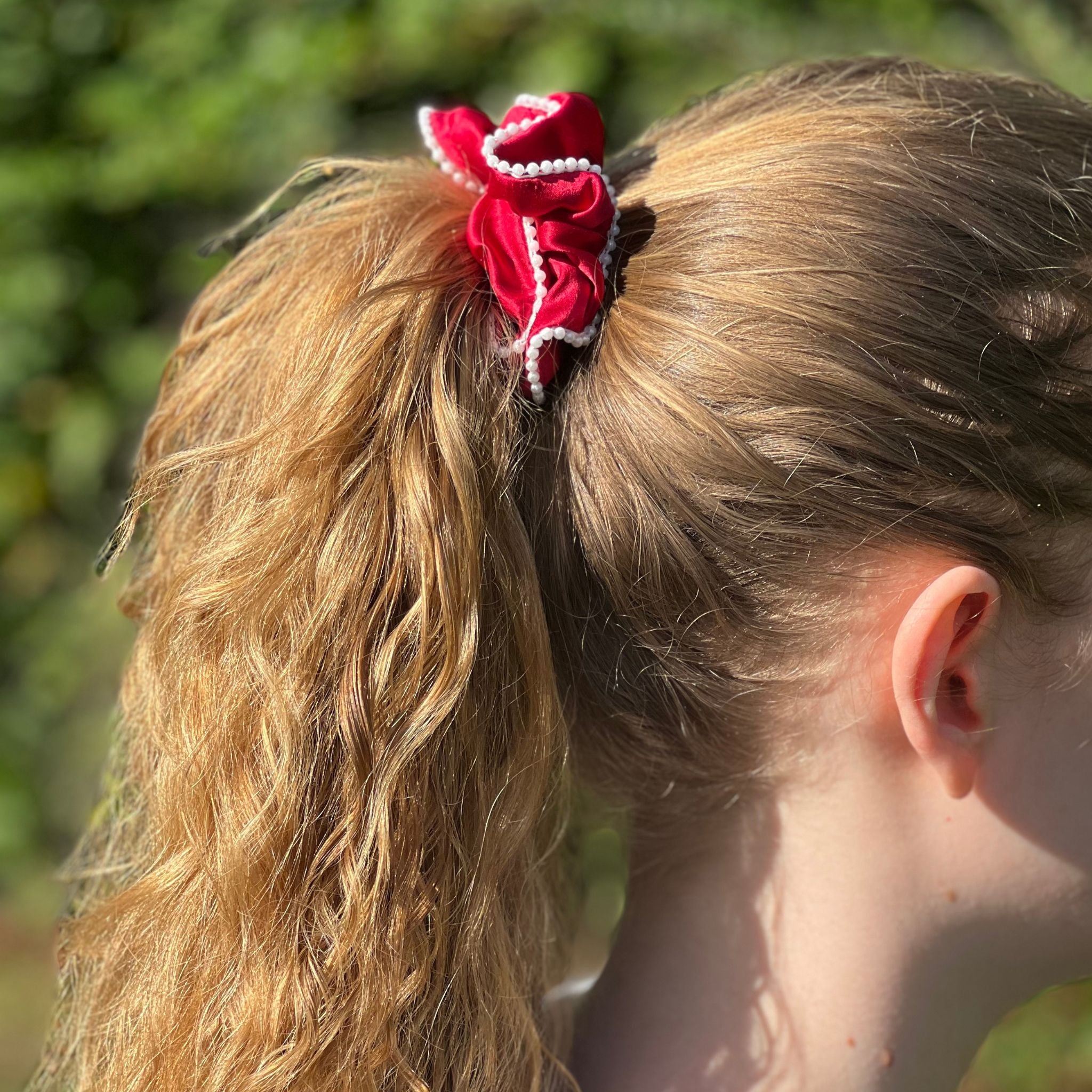 red beaded silk scrunchie in a high ponytail