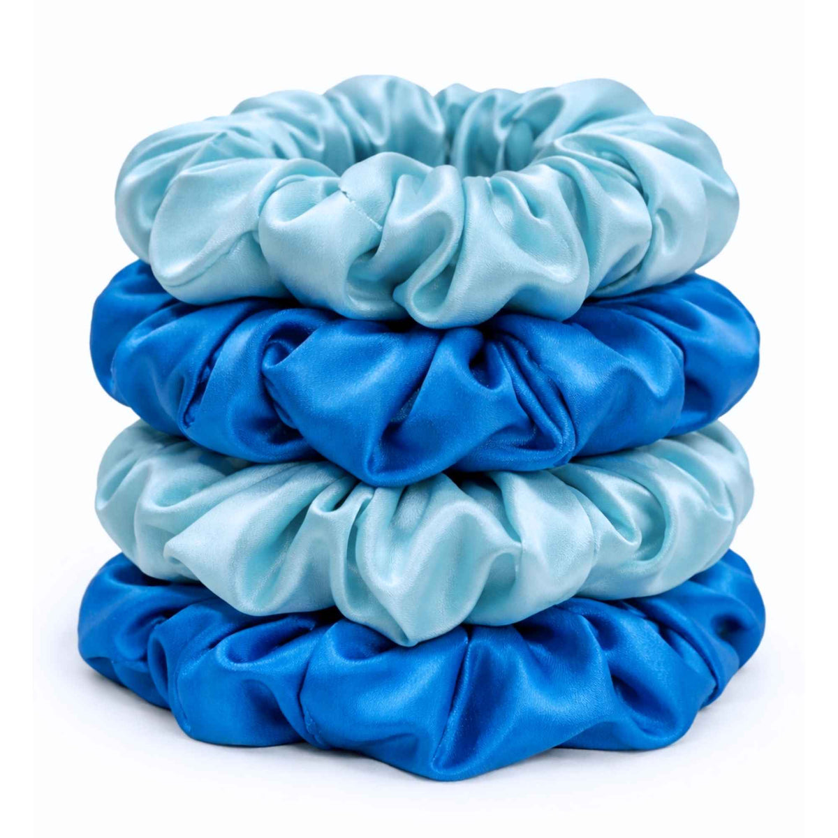 Stack of robins egg blue and crystal teal silk scrunchies on a white background