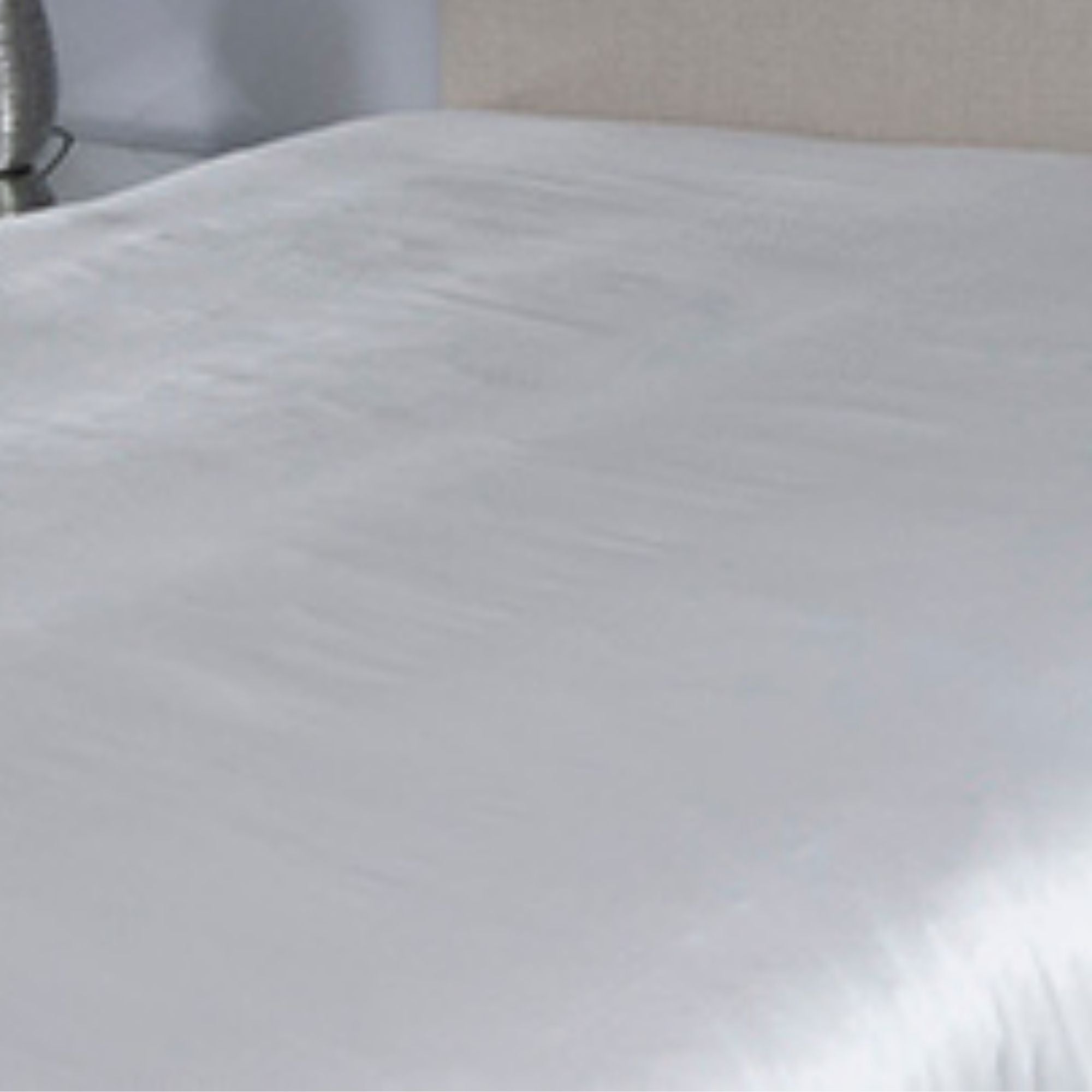 Close-up of an ivory silk seamless sheet with a blurred background