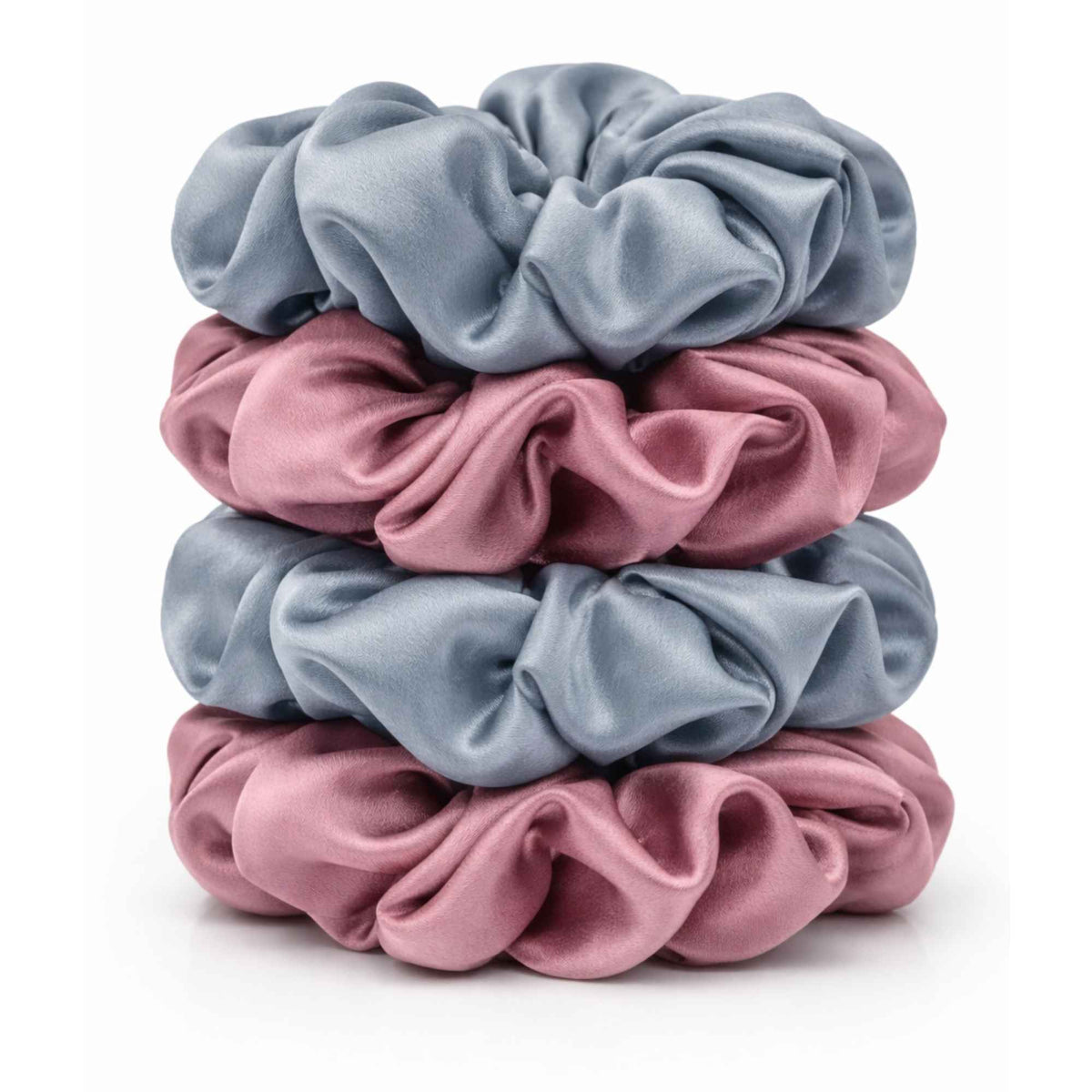 stack of four silk scrunchies in the colours dusty blue and dusty pink against a white background