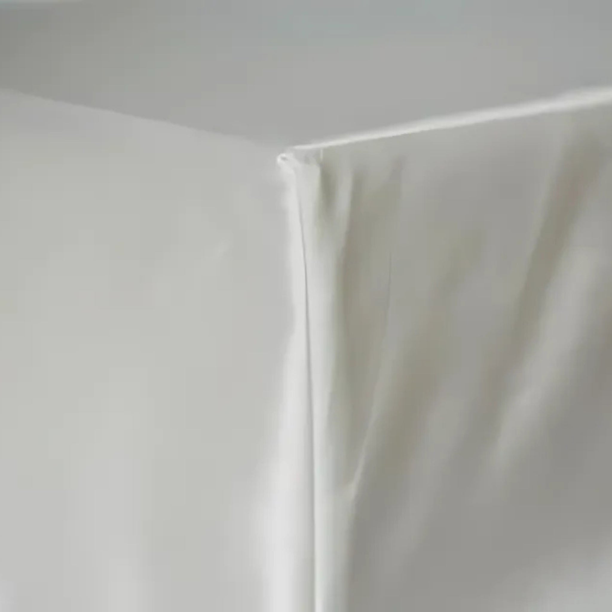 corner of a fitted silk sheet