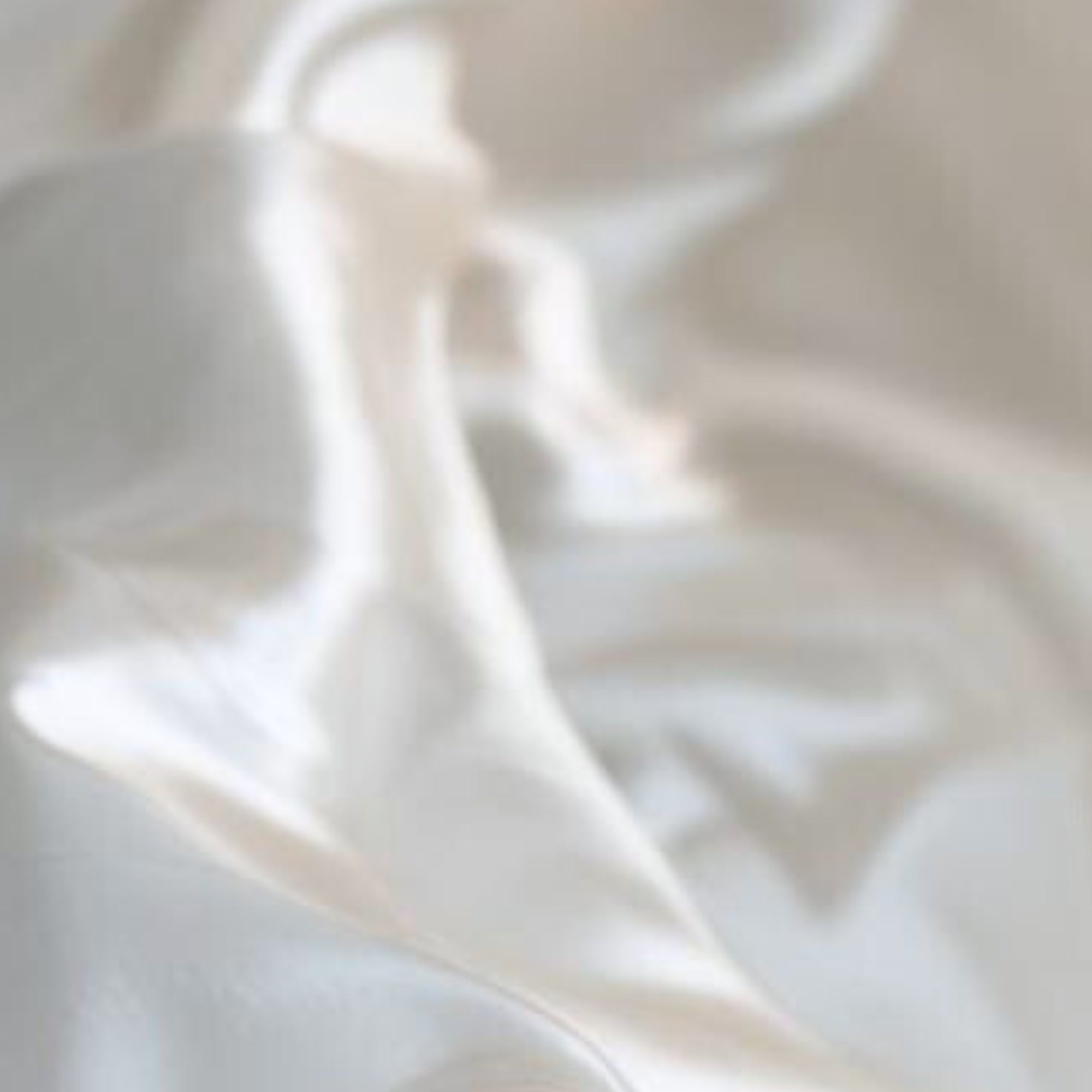 Close-up of ivory silk fabric with soft texture