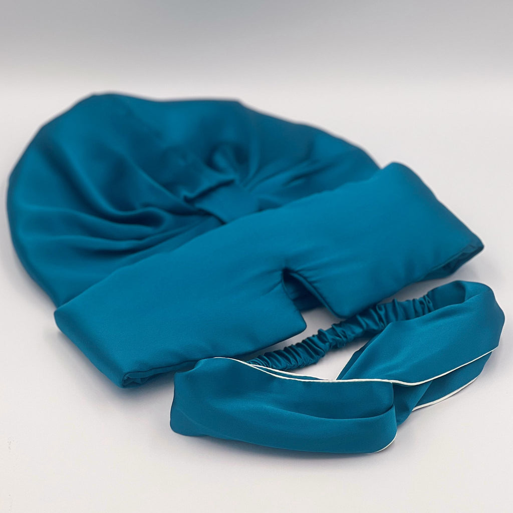 silk teal bonnet, eye mask and headband in a row. The headband also has an ivory trim