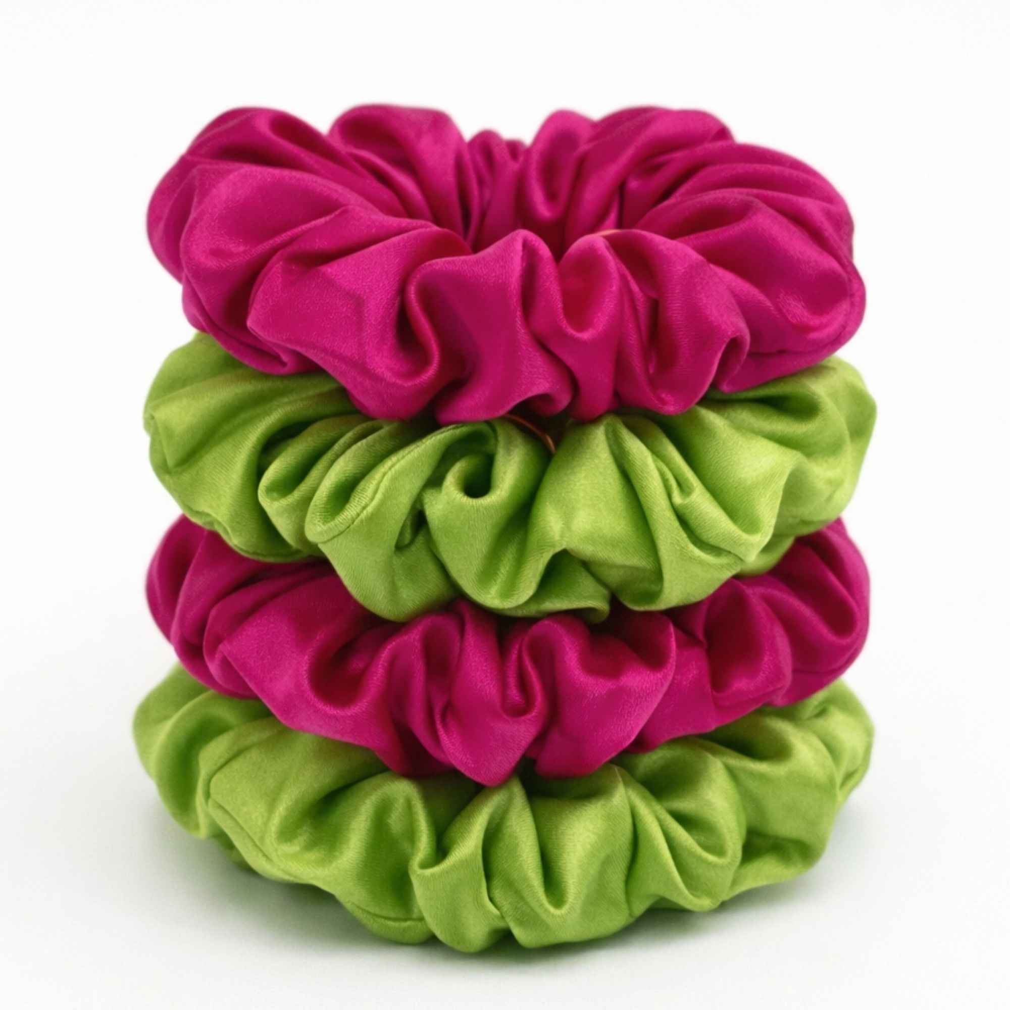 a stack of bright pink and lime green mulberry silk scrunchies