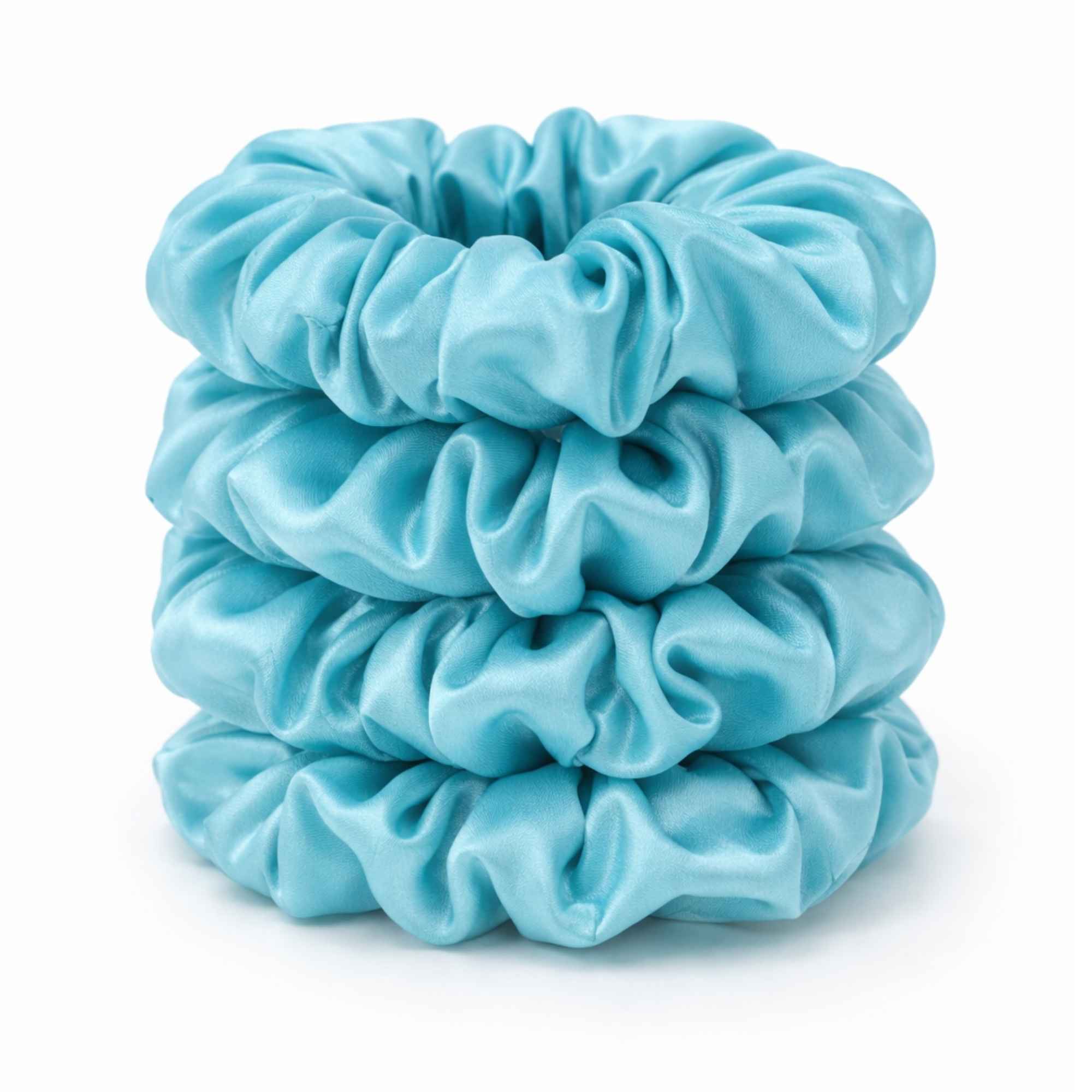 Stack of robins egg blue silk scrunchies on a white background