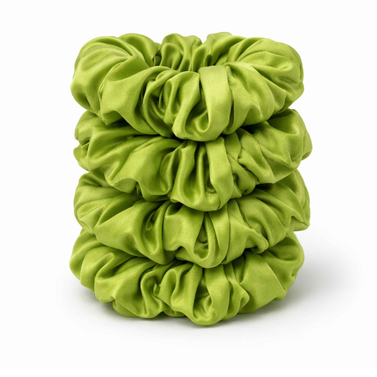 Stack of lime green silk scrunchies on a white background