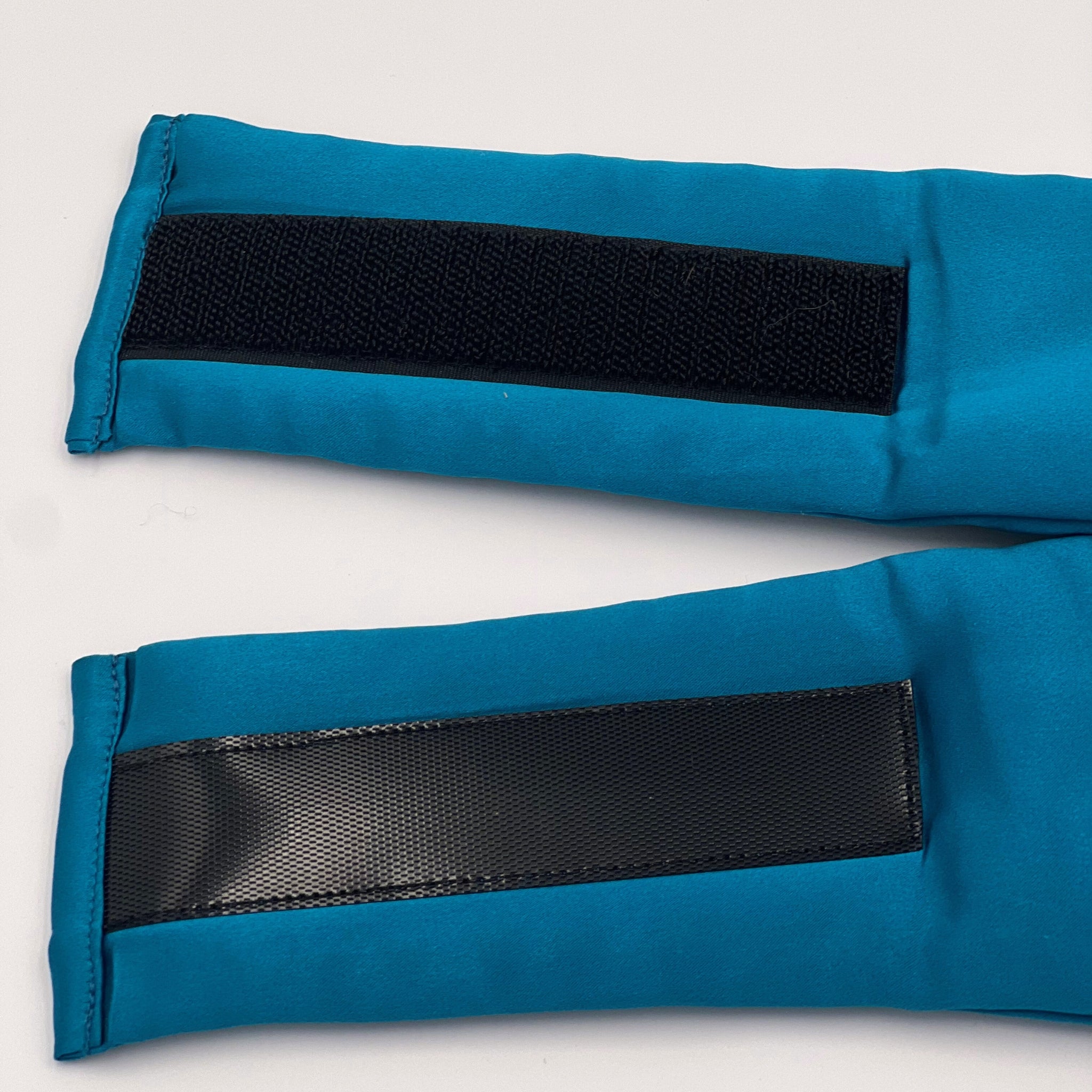 Close up of the velcro of a teal silk eye mask