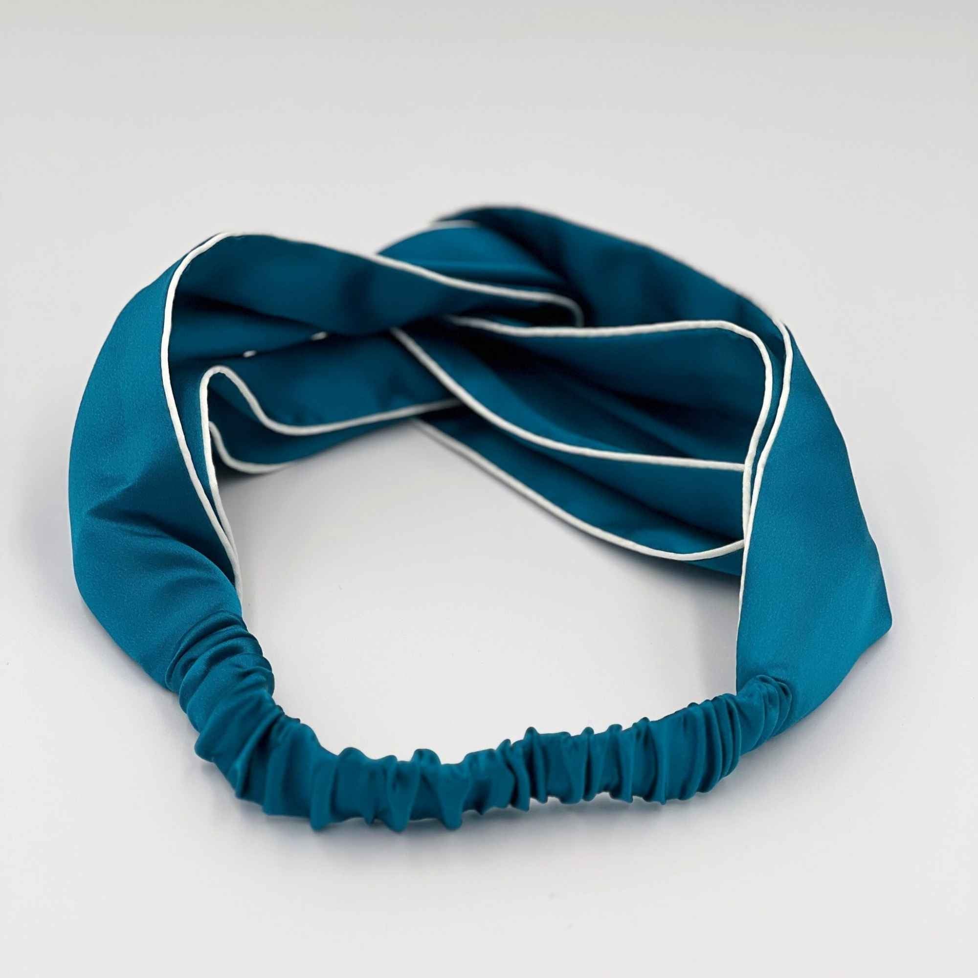 the elasticated back of the teal blue mulberry silk headband