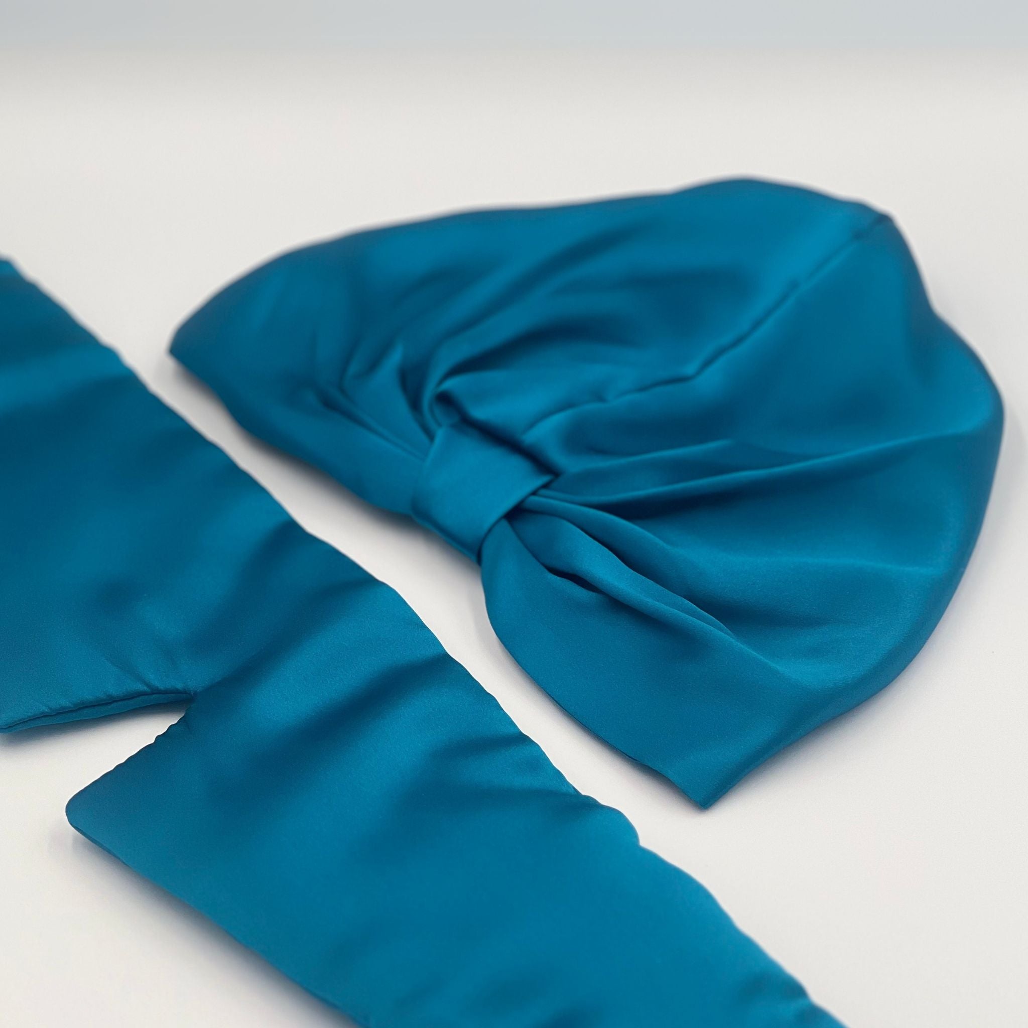 teal silk eye mask and bonnet set with the eye mask opened out to show its length