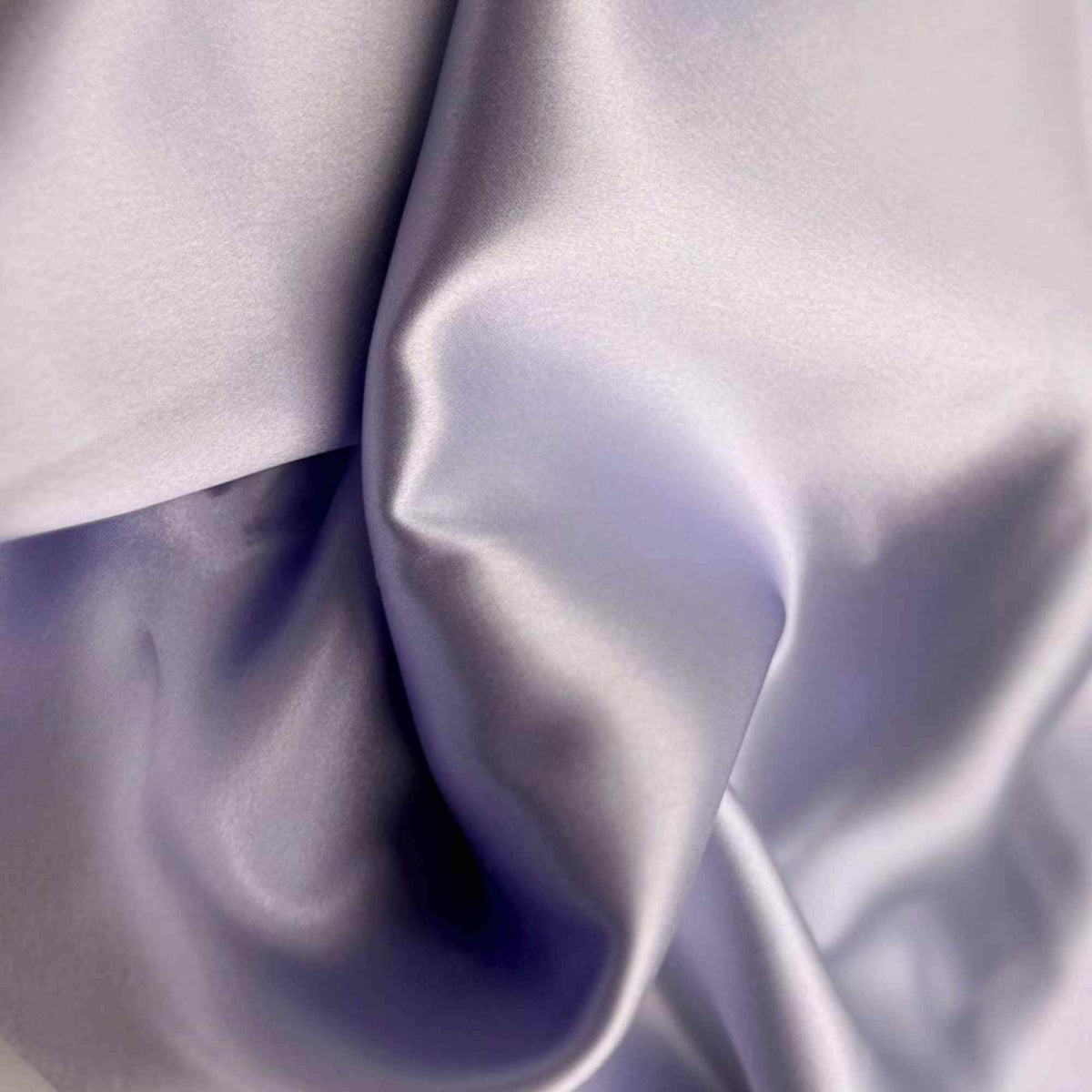 Close-up of smooth, light thistle purple silk fabric with folds