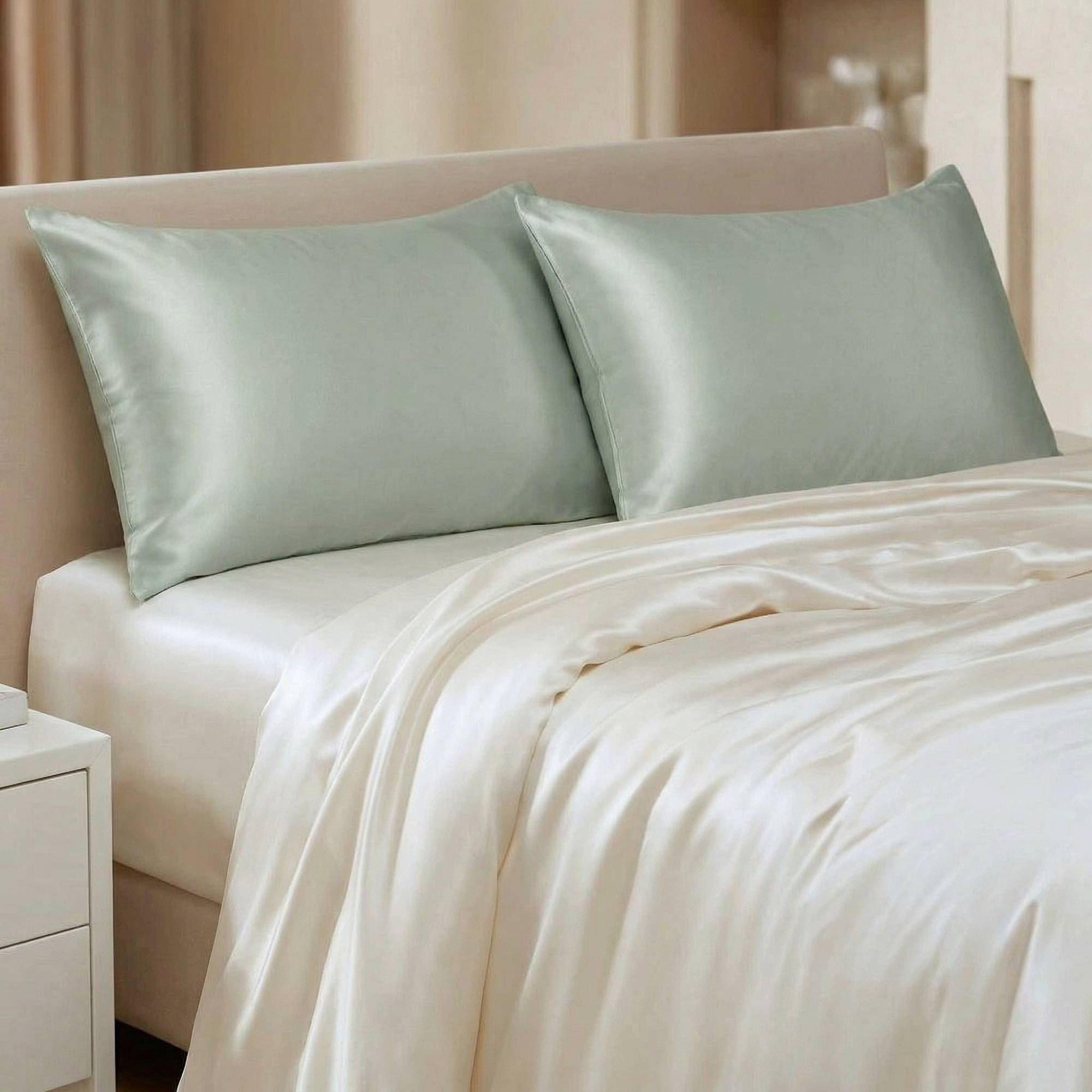 Glace green glace Silk pillowcases on a bed with beige bedding in a bedroom setting