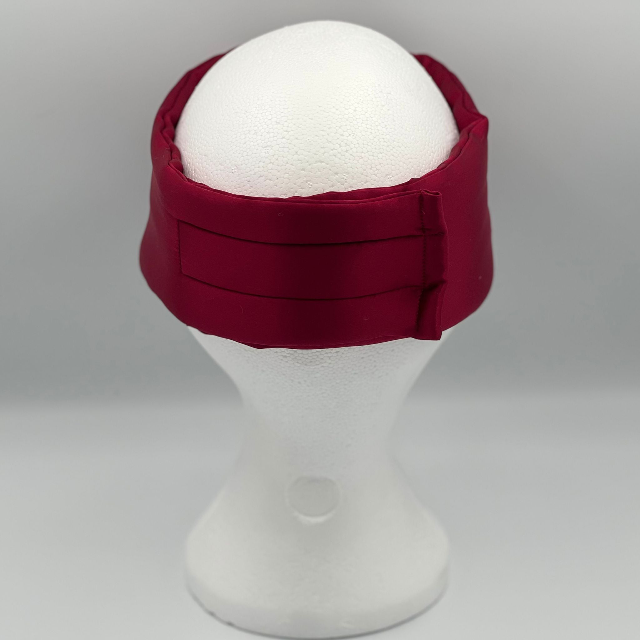 Rear view of a Wine Red silk eye mask on a mannequin